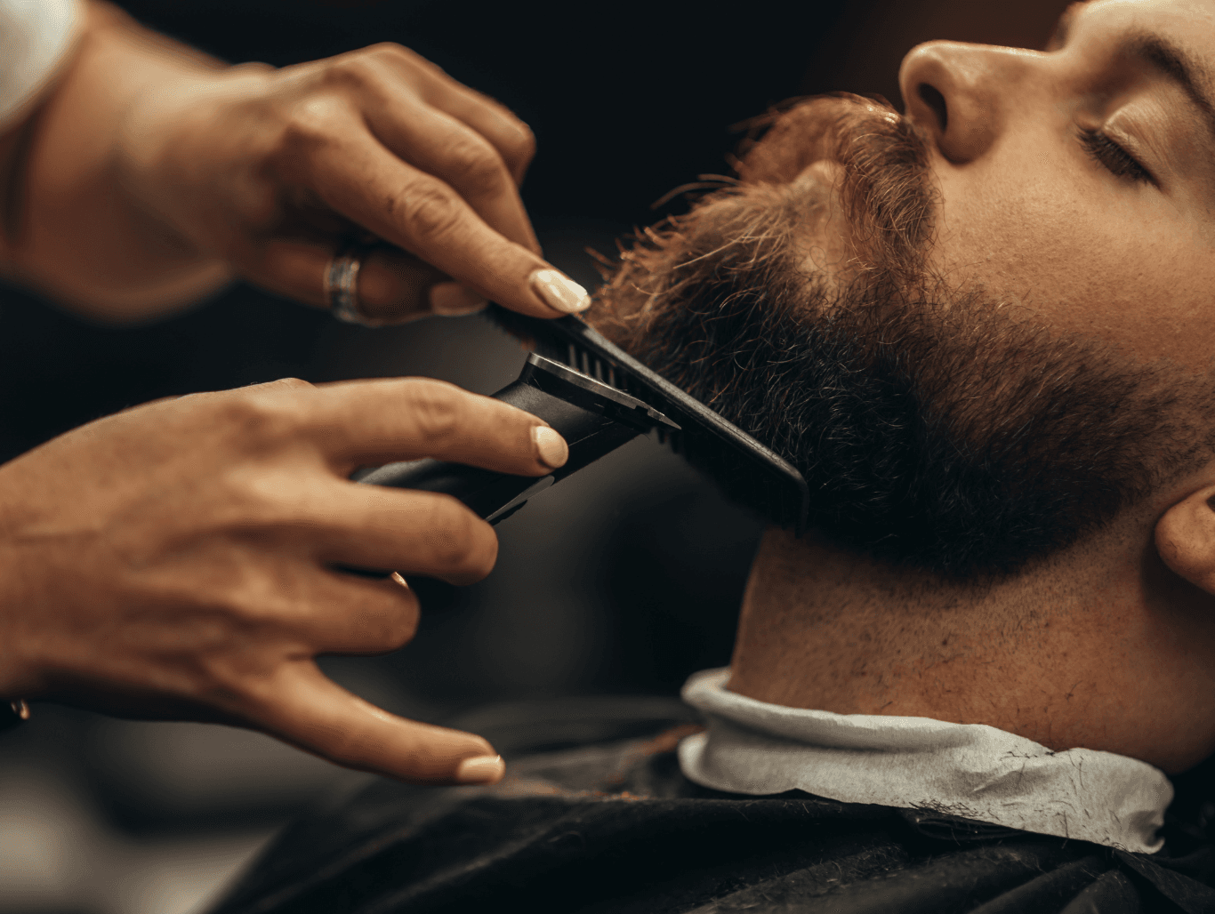 Close-up of a man receiving a professional beard trim at John Richards Hairdressing in Allington, Maidstone, showcasing sharp, precision grooming.