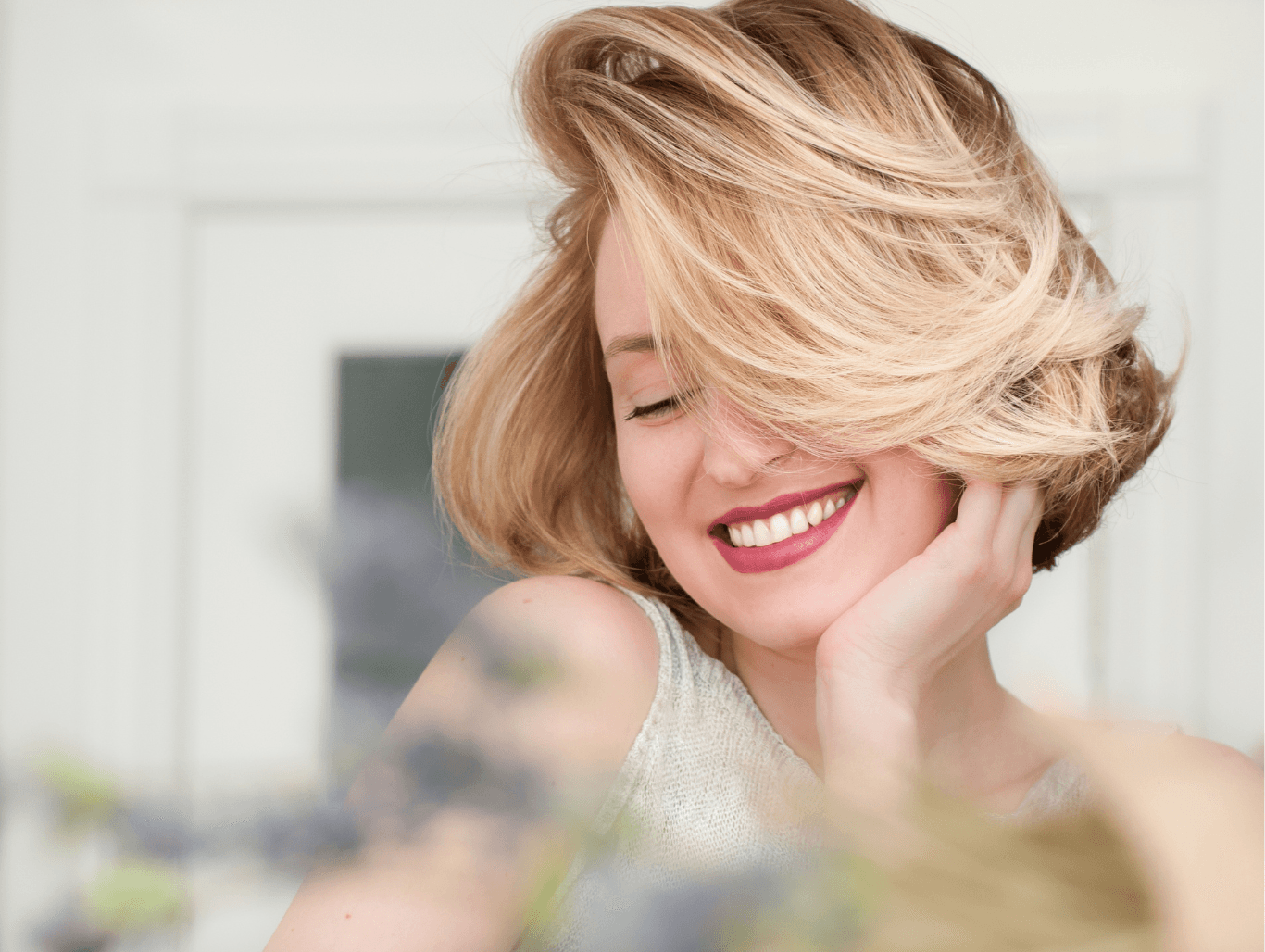 Smiling woman with freshly styled blonde highlights at John Richards Hairdressing, Maidstone