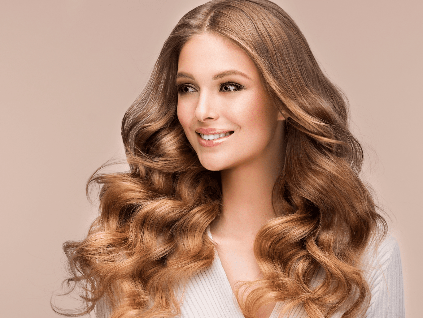 Woman with rich, multi-tonal, wavy hair showcasing expert block highlights (highlights plus full head colour) at John Richards Hairdressing, Allington, Maidstone.