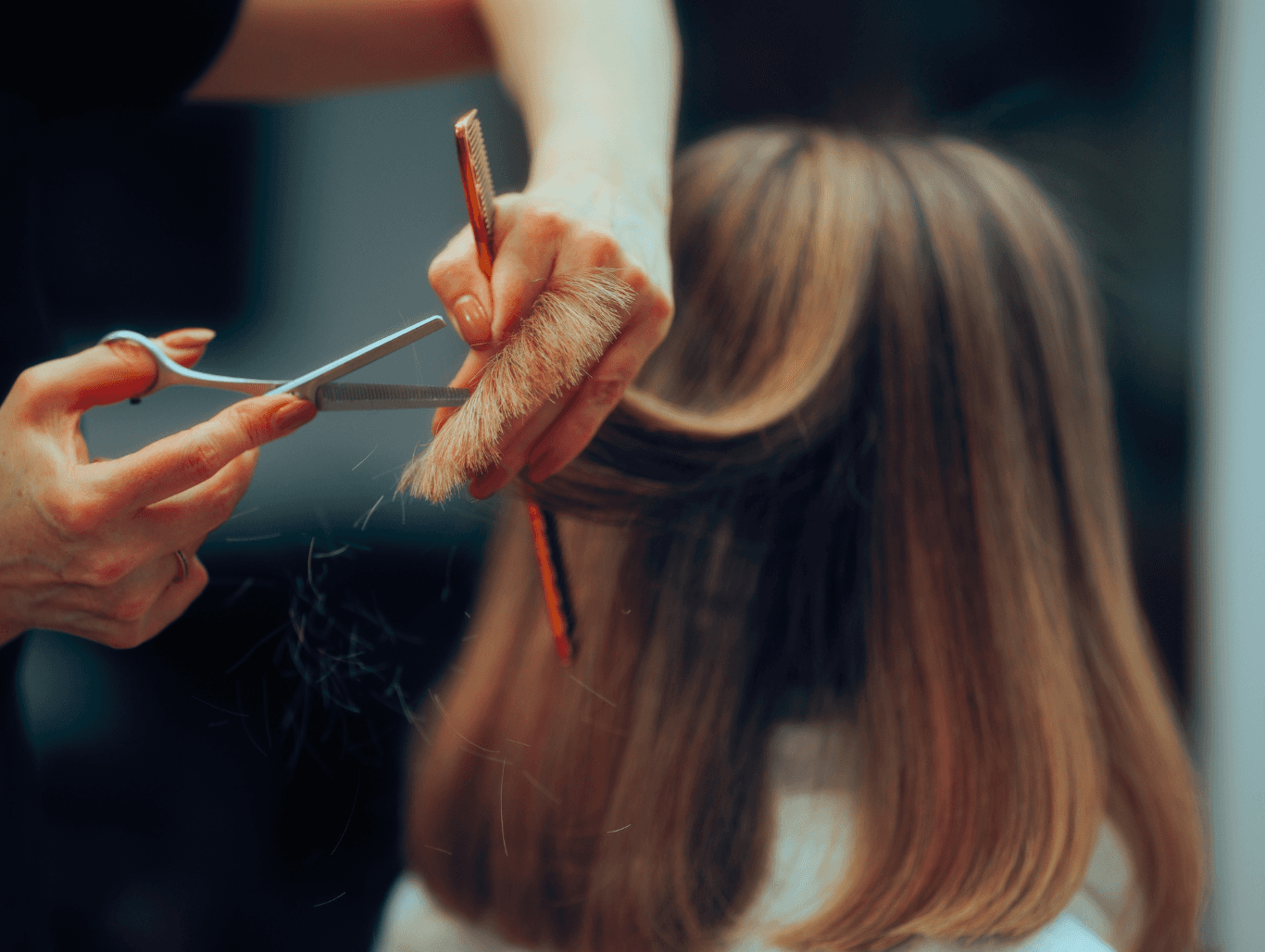 Hair stylist cutting and styling a woman’s hair at John Richards Hairdressing in Allington, Maidstone, specialising in precision cuts and expert styling for all hair types.