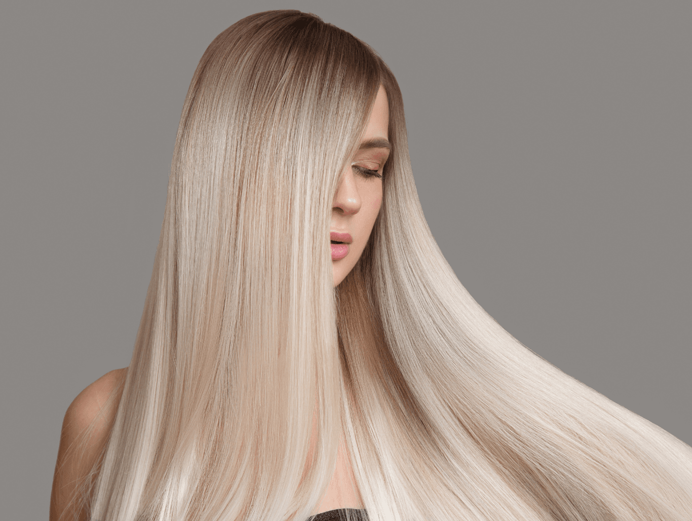 Woman with long, sleek, freshly highlighted blonde hair, showcasing expert full head highlights at John Richards Hairdressing in Allington, Maidstone.