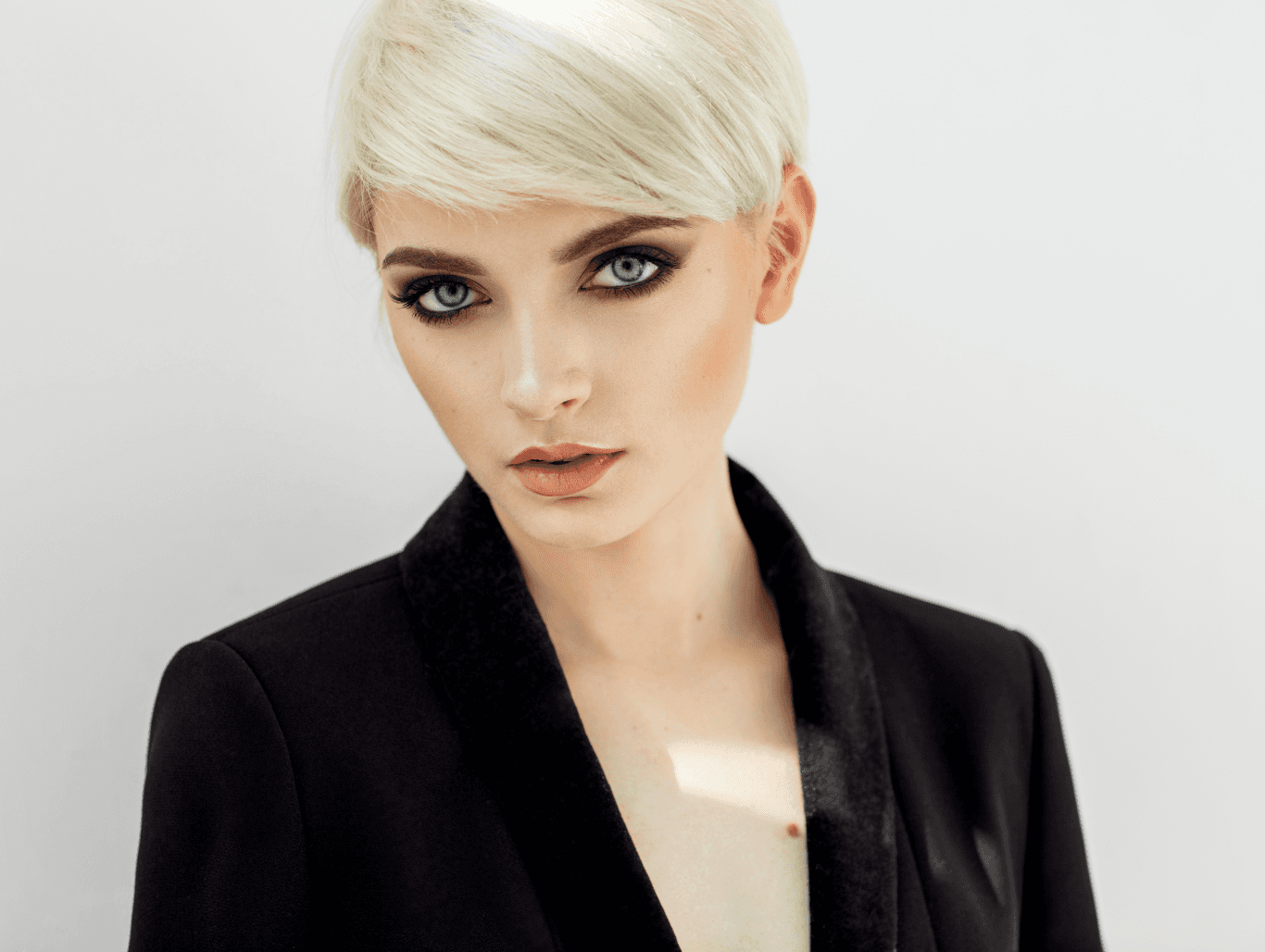 Woman with sleek, cool-toned blonde hair showcasing a perfectly applied toner at John Richards Hairdressing, Allington, Maidstone.