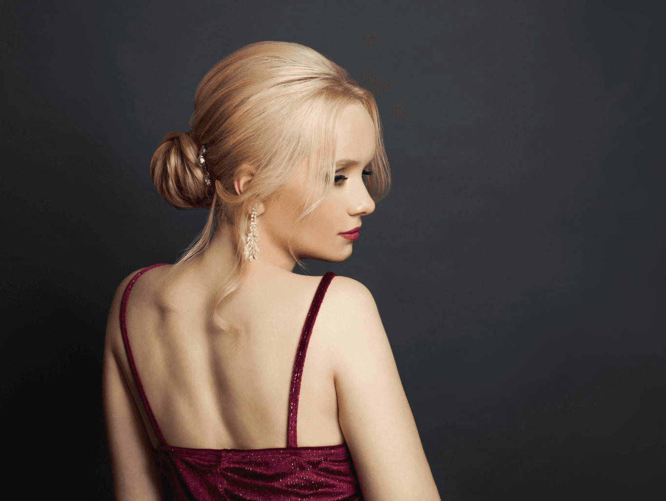 Woman with an elegant updo hairstyle, accessorised for a formal occasion, styled at John Richards Hairdressing, Allington, Maidstone.