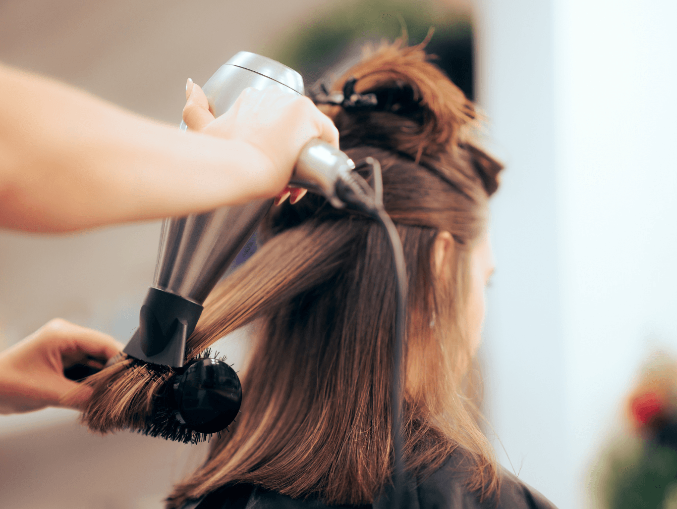 Woman receiving a professional blow dry at John Richards Hairdressing in Allington, Maidstone, showcasing smooth, polished, and healthy-looking hair.