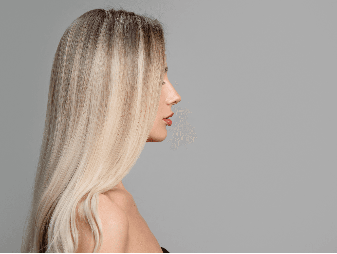 Woman with long, sleek, multi-tonal blonde hair, showcasing expertly applied three quarter head highlights at John Richards Hairdressing, Allington, Maidstone.